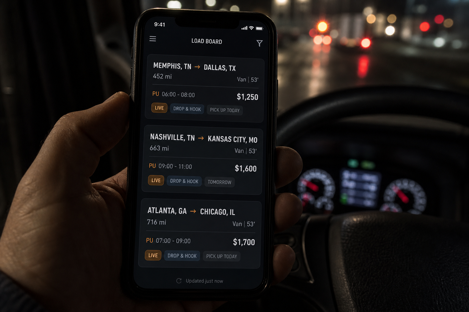 Dispatch load board on a phone in a truck cab at night.